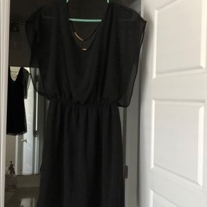 Black cocktail dress with gold details in the back